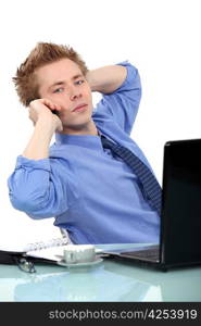 Young business man stretching at desk