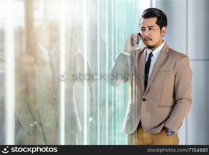 young business man talking with mobile phone in office