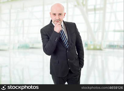 young business man thinking, at the office