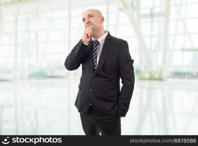 young business man thinking, at the office