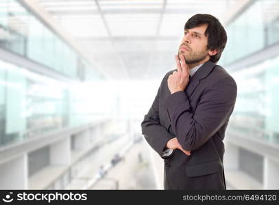 young business man thinking, at the office. businessman thinking