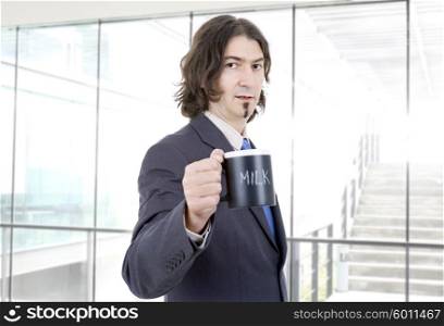 young business man with a cup of milk at the office