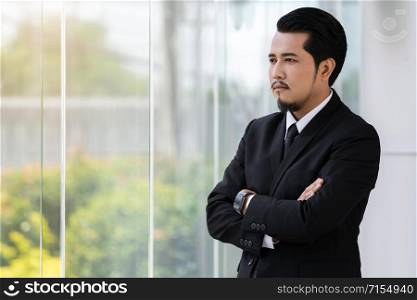 young business man with arms crossed
