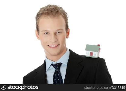 Young business man with house model - real estate concept. Isolated on white