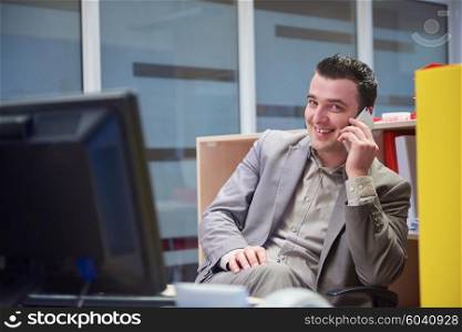 young business man working on computer and talking by phone on modern office indoors