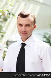 young business man working with documents in garden