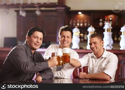 Young business men in a bar with beer