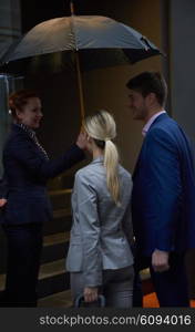 Young business people couple entering city hotel, looking for room, holding suitcases while walking on street