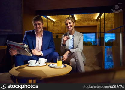 young business people couple relaxing after work in bar restaurant and take drink