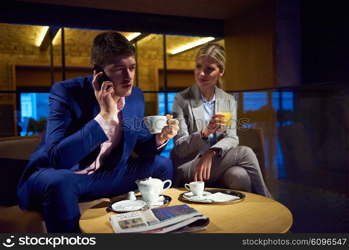 young business people couple relaxing after work in bar restaurant and take drink