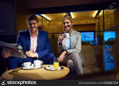 young business people couple relaxing after work in bar restaurant and take drink