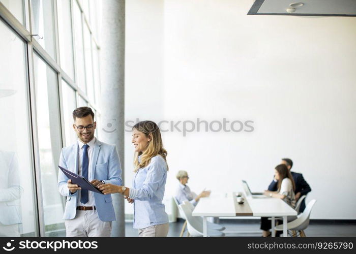 Young business people looking a file in a modern office