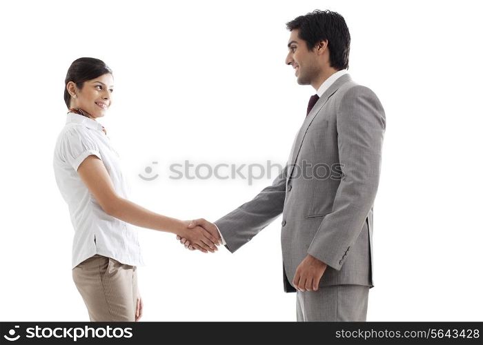 Young business people shaking hands over white background