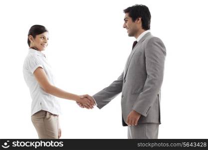 Young business people shaking hands over white background