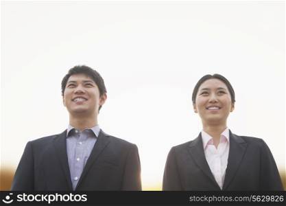 Young business people smiling