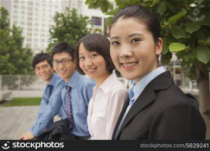 Young business people smiling and looking at the camera, portrait