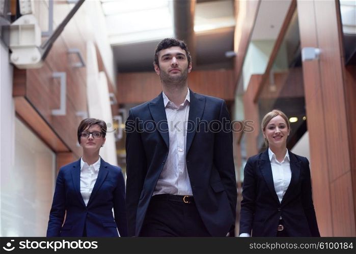 young business people team walking, group of people on modern office hall interior
