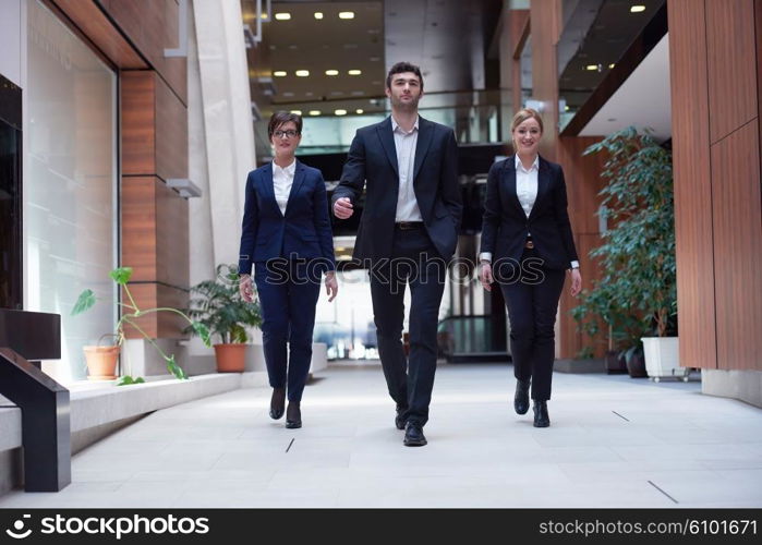 young business people team walking, group of people on modern office hall interior