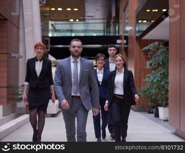 young business people team walking, group of people on modern office hall interior