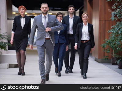 young business people team walking, group of people on modern office hall interior