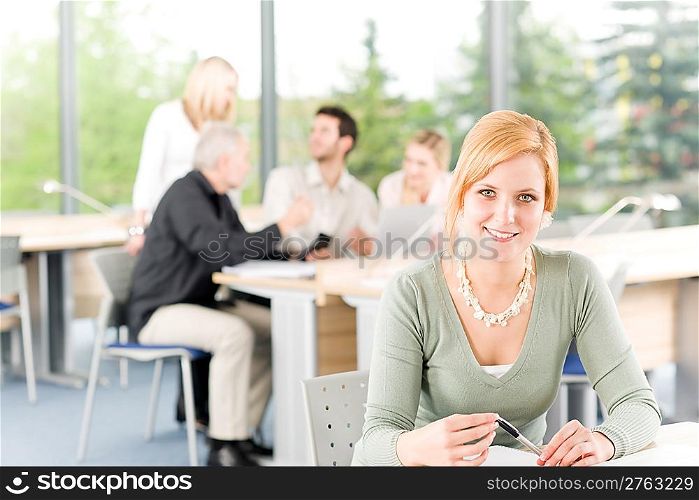 Young business students having meeting - businesswoman in front