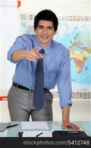 young business teacher pointing at you