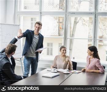 Young business team enjoying success at conference table