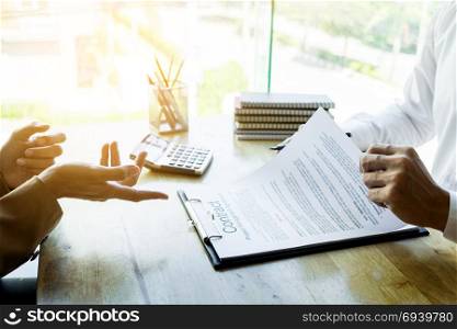 Young business team working with new startup project offering contract paper to his business partner for sign contract in conference room. discussing. Business accounting financial meeting concept.