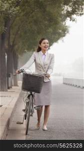 Young Business Woman commuting with a Bicycle, Beijing, China