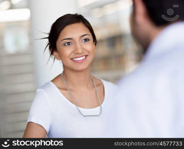 Young business woman having conversation with her collegue