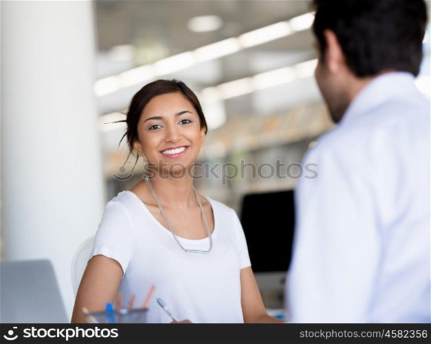 Young business woman having conversation with her collegue