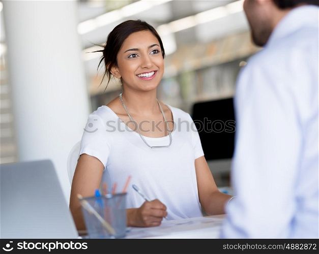 Young business woman having conversation with her collegue