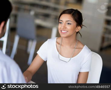 Young business woman having conversation with her collegue