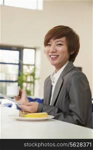 Young business woman in company cafeteria
