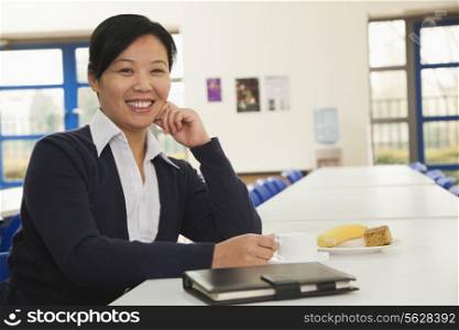 Young business woman in company cafeteria