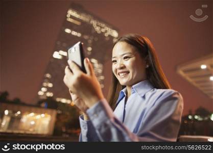 Young business woman looking at the phone