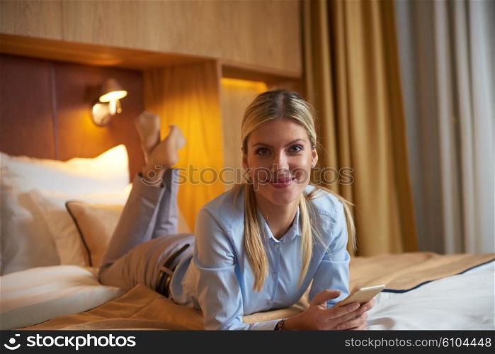 young business woman relaxing in hotel room and looking tv