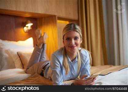 young business woman relaxing in hotel room and looking tv