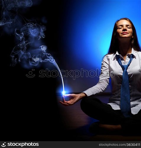 Young business woman sitting in asana lotus and meditating