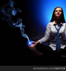 Young business woman sitting in asana lotus and meditating