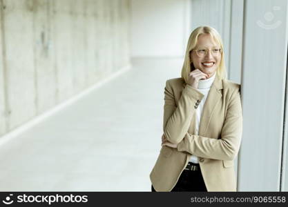 Young business woman standing in the office corridor