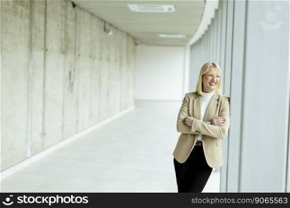 Young business woman standing in the office corridor