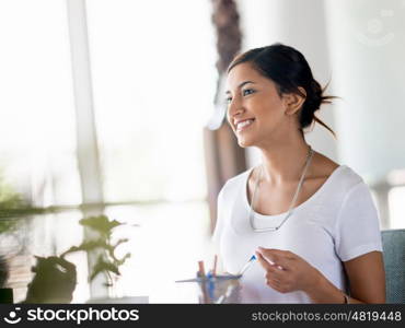 Young business woman talking to her collegue and smiling