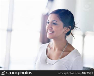 Young business woman talking to her collegue and smiling