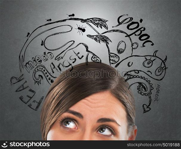 Young business woman thinking of her fearsand doubts closeup face portrait and sketches overhead