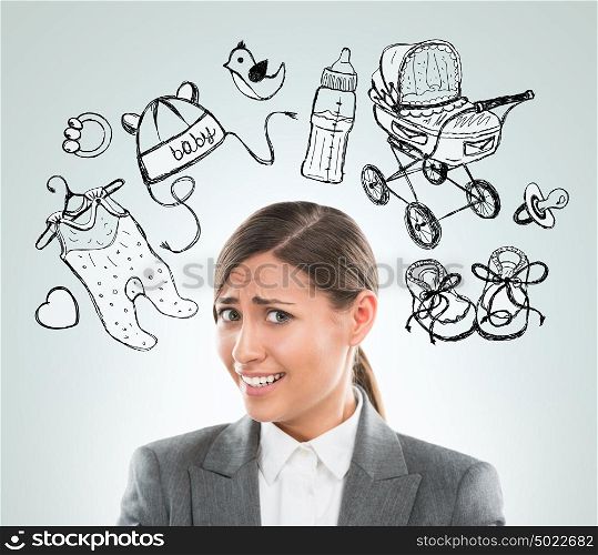 Young business woman thinking of her pregnancy plans closeup face portrait and sketches overhead