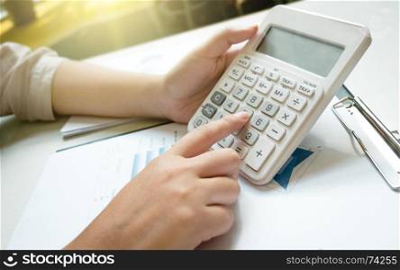 young business woman using calculator