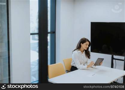 Young business woman with digital tablet in the modern office