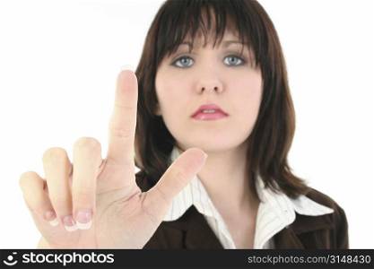 Young business woman with finger up as if pressing screen. Shot in studio over white.