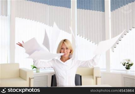 young business woman with papers flying up